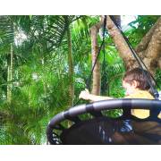 Child sitting on the 100cm black nest swing hung from a tree