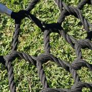 Close up of the black net ropes over grass