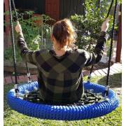 Woman on the heavy duty blue rope nest swing, from behind