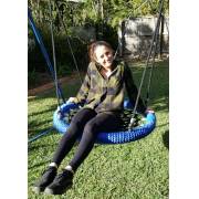 Woman sitting on the heavy duty blue rope nest swing in a garden