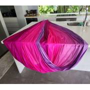 Pink purple wrap swing opened out as a hammock in a kitchen